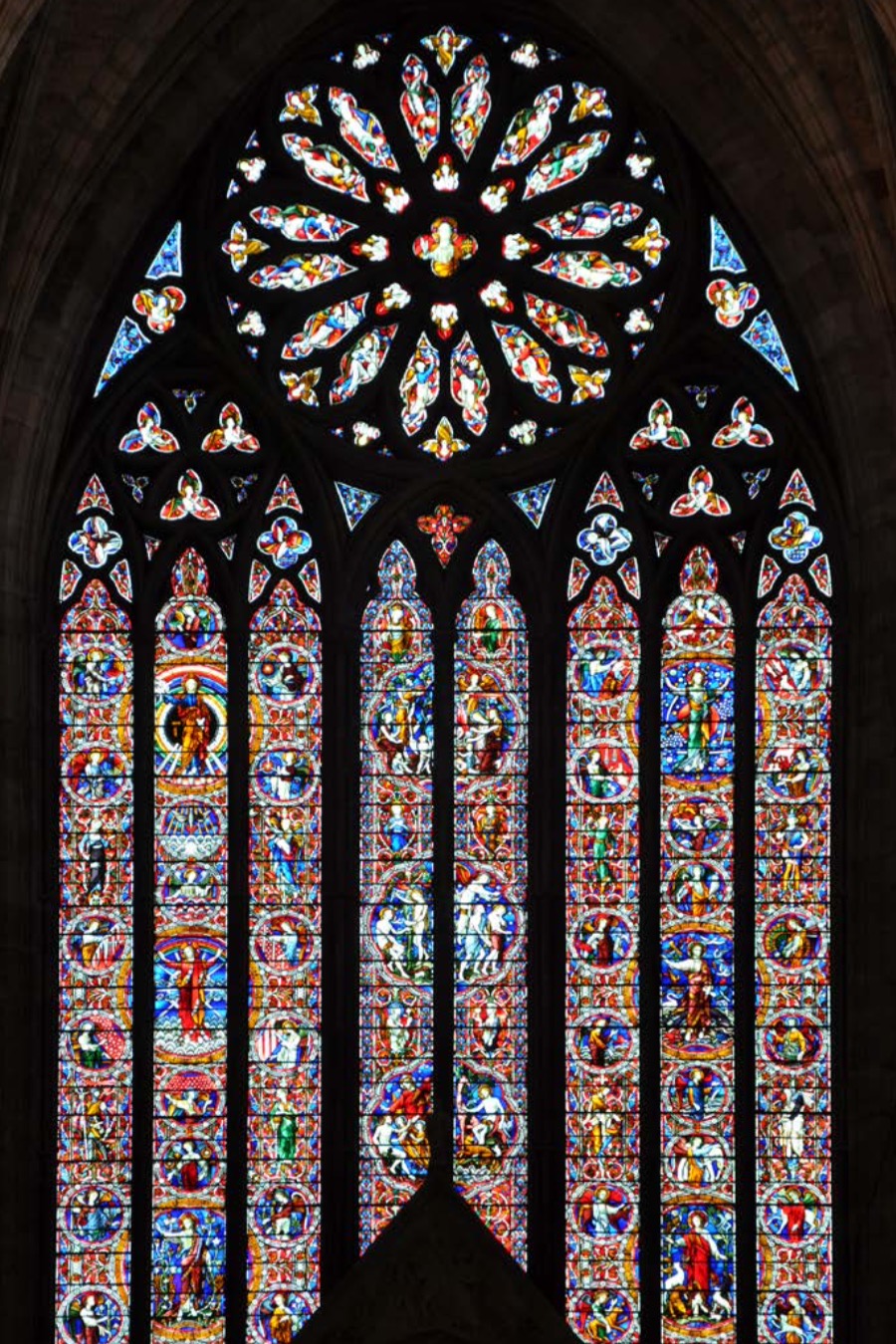 Eight vertical lights (each 8.6 × 0.7 m) with brightly coloured glass in medallions; tracery and rose window (diameter 4.2 m) above; designed by John Hardman Powell and made by Hardman & Co. of Birmingham
